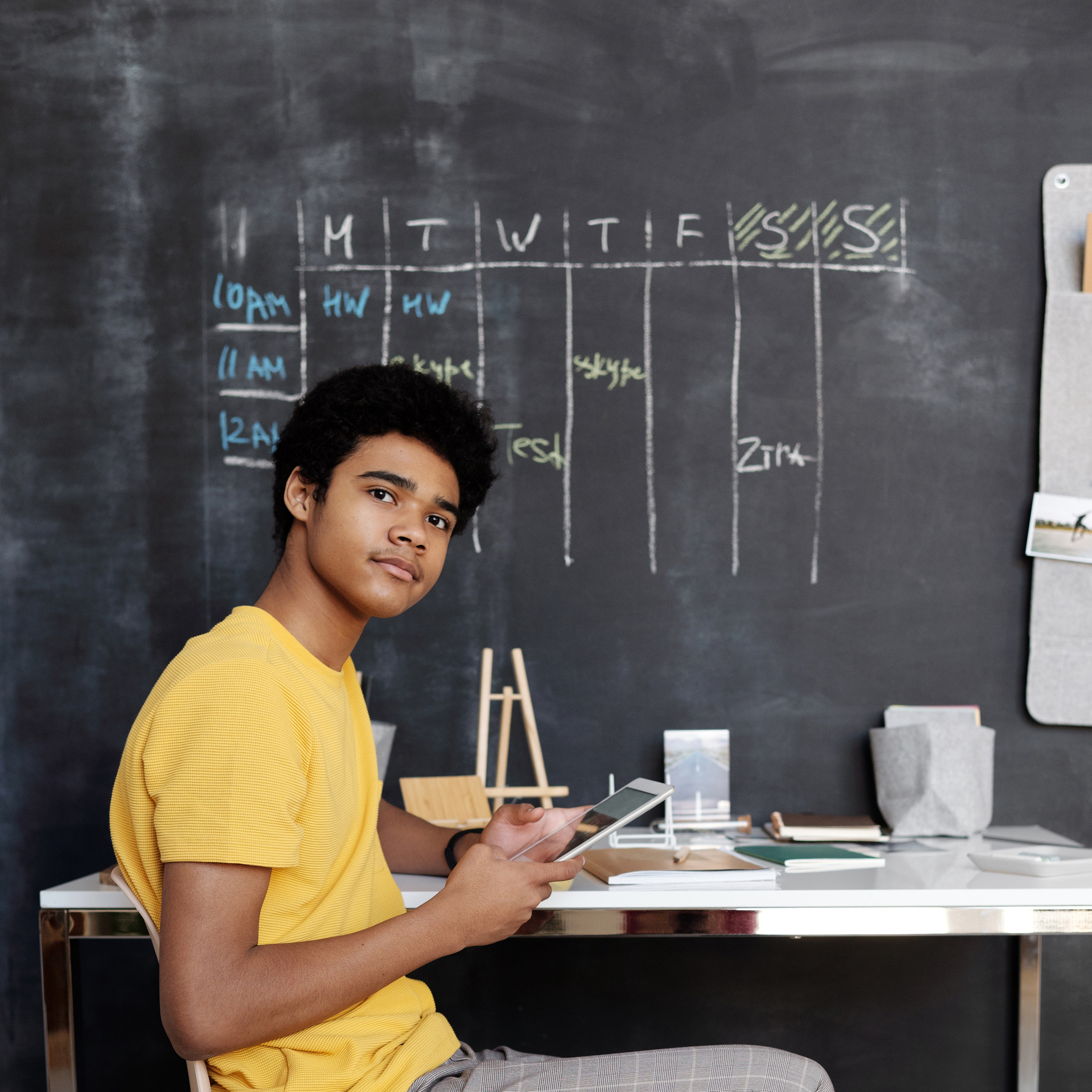 photo-of-boy-sitting-on-chair-while-holding-an-ipad-4144095.jpg